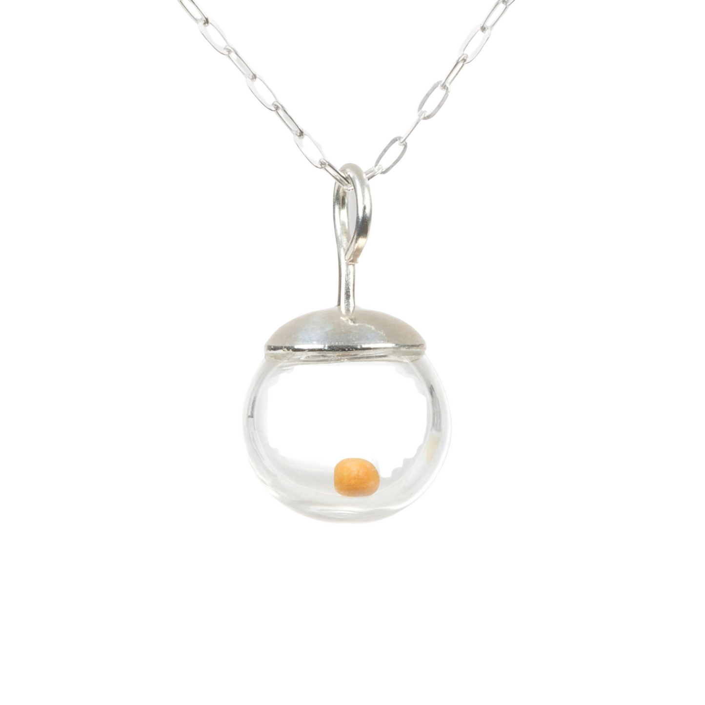 Close-up photo of a delicate 10mm mustard seed necklace (pendant is slightly less than 1/2 inch diameter) featuring a tiny real mustard seed encased in a clear hand-blown glass globe. The globe is topped with a smooth, solid 925 sterling silver cap and suspended from a fine sterling silver cable chain. The mustard seed floats freely inside the miniature globe, creating a simple yet meaningful design.