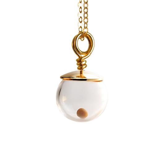 Close-up of a 14K gold-filled mustard seed necklace against a white background, featuring a single real mustard seed enclosed in a clear 10mm hand-blown glass globe with a polished gold-filled cap and wire-wrapped loop, suspended from a delicate gold-filled cable chain.