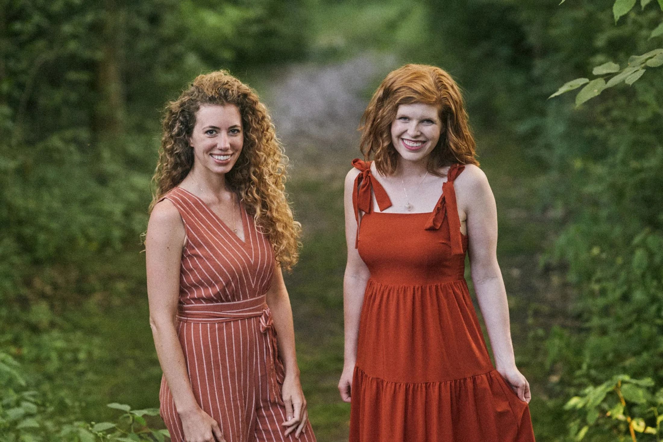 Women wearing mustard seed necklaces in a wildflower field