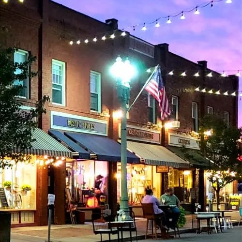 4th Street in downtown Canton, Ohio at dusk, shopfronts lit under string lights
