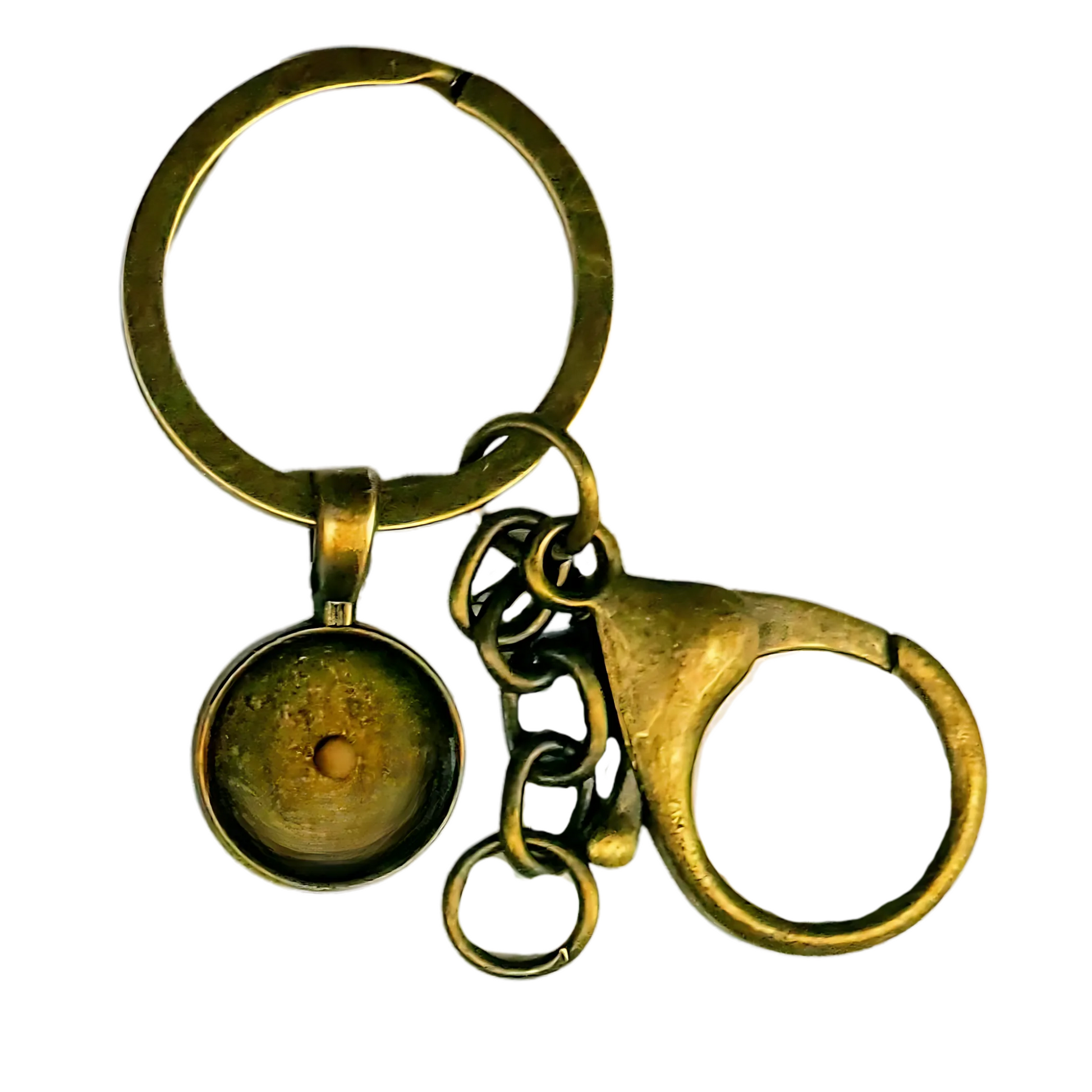 Close-up image of a small bronze keychain featuring a round pendant with a single real mustard seed sealed in clear resin at the center. The pendant is encased clear resin within a vintage bronze bezel, giving it a warm, rustic appearance. Attached to a sturdy key ring, the keychain also includes a large bronze lobster clasp for smooth, secure attachment to keys, bags, or gear. A meaningful, faith-based accessory with minimalist design.