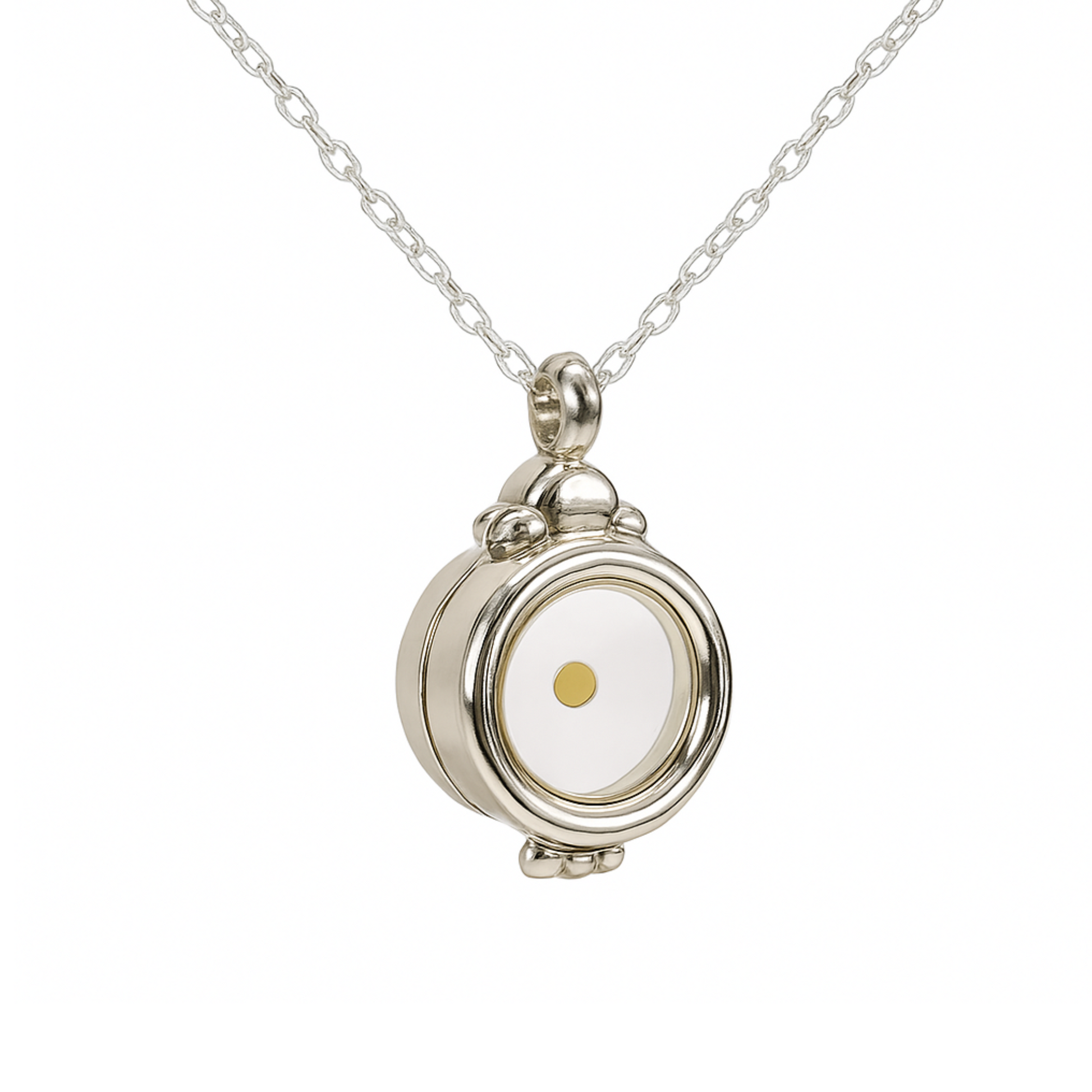 Silver locket necklace hanging in a V-shape on a delicate chain, with the pendant slightly angled to the left, revealing both the front and side profile. The round locket features a clear window encasing a single mustard seed and is adorned with ornate silver detailing. Displayed on a clean white background.