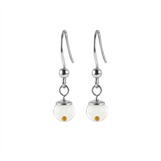A professional product image of a pair of dangle mustard seed earrings against a pure white background, featuring polished 925 sterling silver Shepard hooks with metallic bead accents, hanging down to clear glass globes that each contain a single yellow mustard seed.