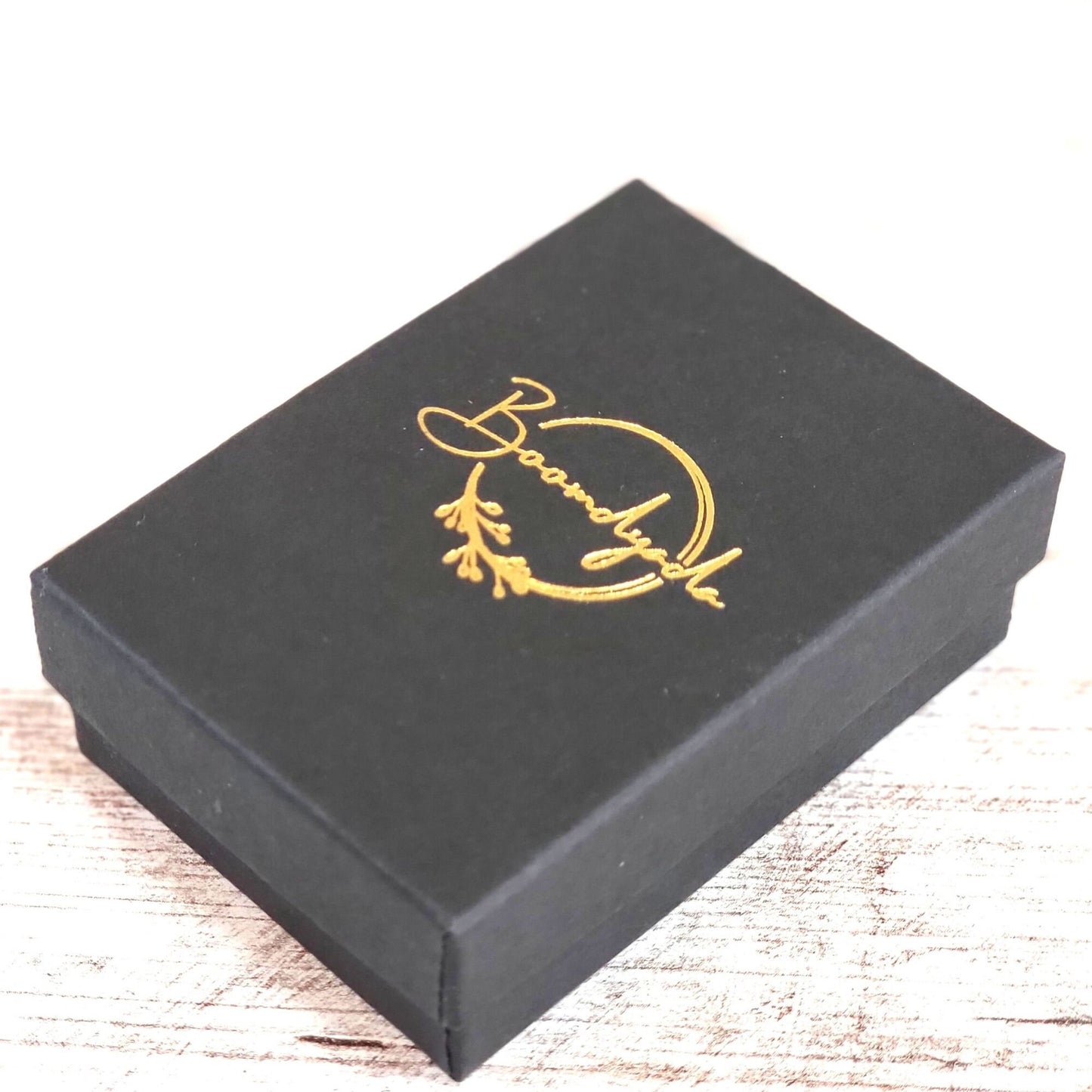 Your necklace will arrive in a black matte jewelry box with a gold foil-stamped Boomdyada logo centered on the outside of the lid. This elegant box is perfect for gift-giving! All orders ship the next business day.